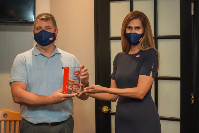 Jason Trotter, left, operations manager at Suburban Propane’s Philadelphia/Telford location, receives the 2020 SuburbanCares award from Nandini Sankara, spokesperson, Suburban Propane for selflessly helping save the lives of two local teens.