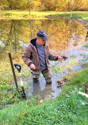 Joe Young demonstrates how to make a pocket set at the water's edge to catch raccoons during the Ohio State Trappers Association Region B Fall meet on Oct. 17 at the Killbuck Valley Sportsman's Club.