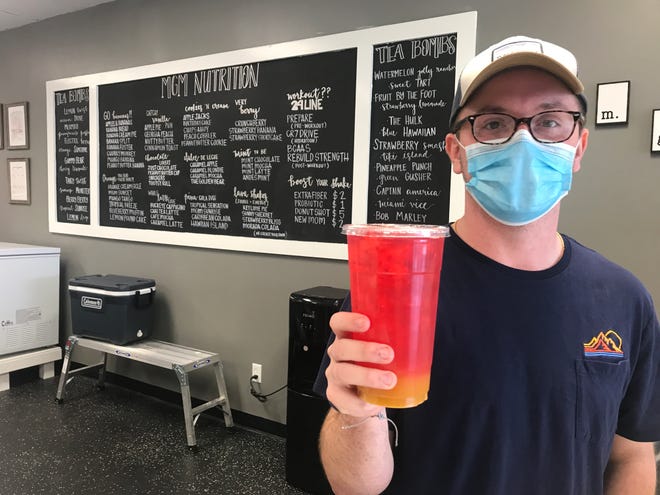 Co-owner Logan Wallace serves a drink at MGM Nutrition in Montgomery.
