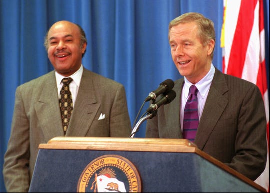 Gov. Pete Wilson, right, and Ward Connerly, who in 1996 led the fight to pass Proposition 209, smile as they talk to reporters in Sacramento, California in 1997. Prop 209 amended the state constitution to ban affirmative action practices in public education and hiring. This election day, state voters will pass judgment on Prop 16, which would repeal Prop 209. Connerly is staunchly opposed to 16.