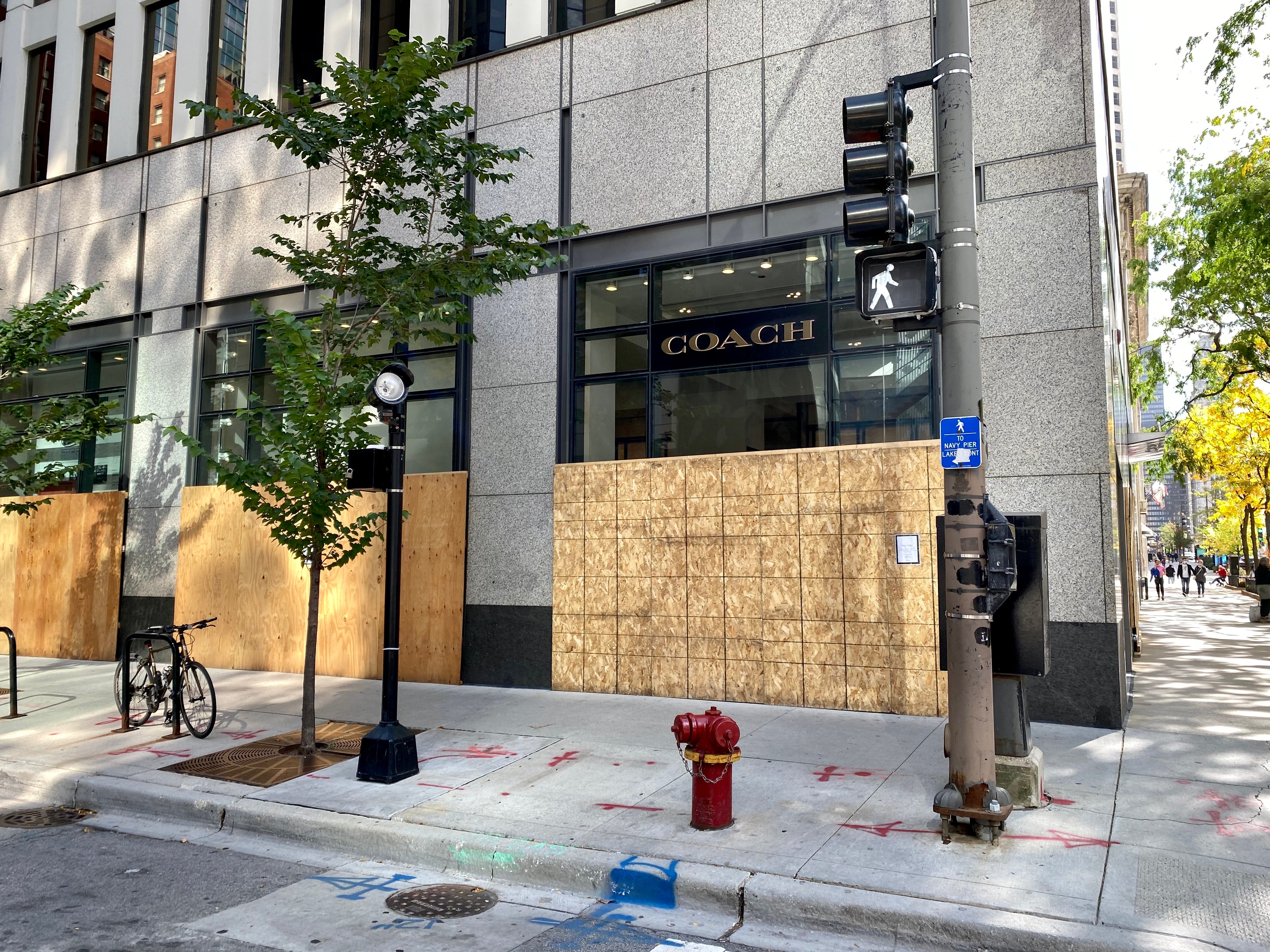 Dozens of storefronts in downtown Chicago remain boarded on Oct. 14, 2020.