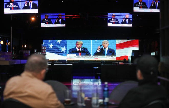 People are pictured watching the final debate between President Donald Trump and Democratic presidential nominee Joe Biden at The Abbey in West Hollywood, California.