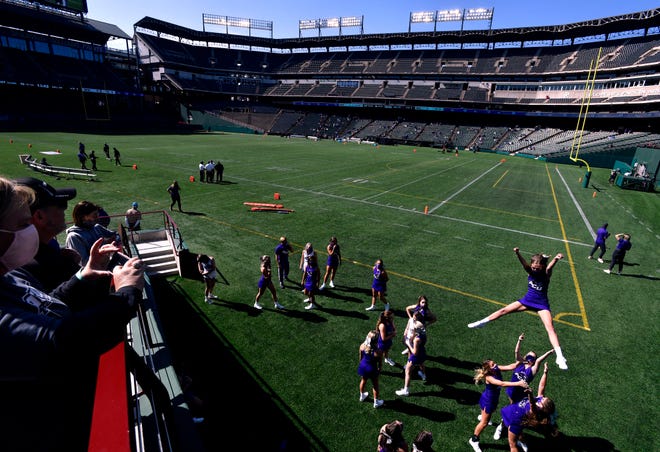 Cheerleaders from Abilene Christian University practice as fan watch Saturday at Globe Life Park. ACU played Stephen F. Austin University in a non-conference football game at the former baseball stadium in Arlington. It was the first college football game played there.