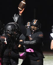 Belleville's Damon Payne celebrates after diving on a fumbled ball in the end zone for a touchdown in the first half.
