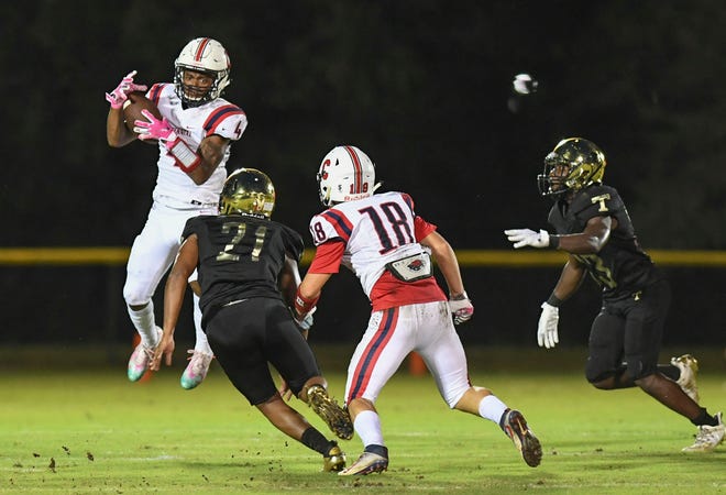 St. Lucie West Centennial's Fresh Walters (left) makes the completion early in the 1st quarter against Treasure Coast at the South County Stadium on Friday, Oct. 23, 2020, in Port St. Lucie. Treasure Coast won over Centennial, 28-20.