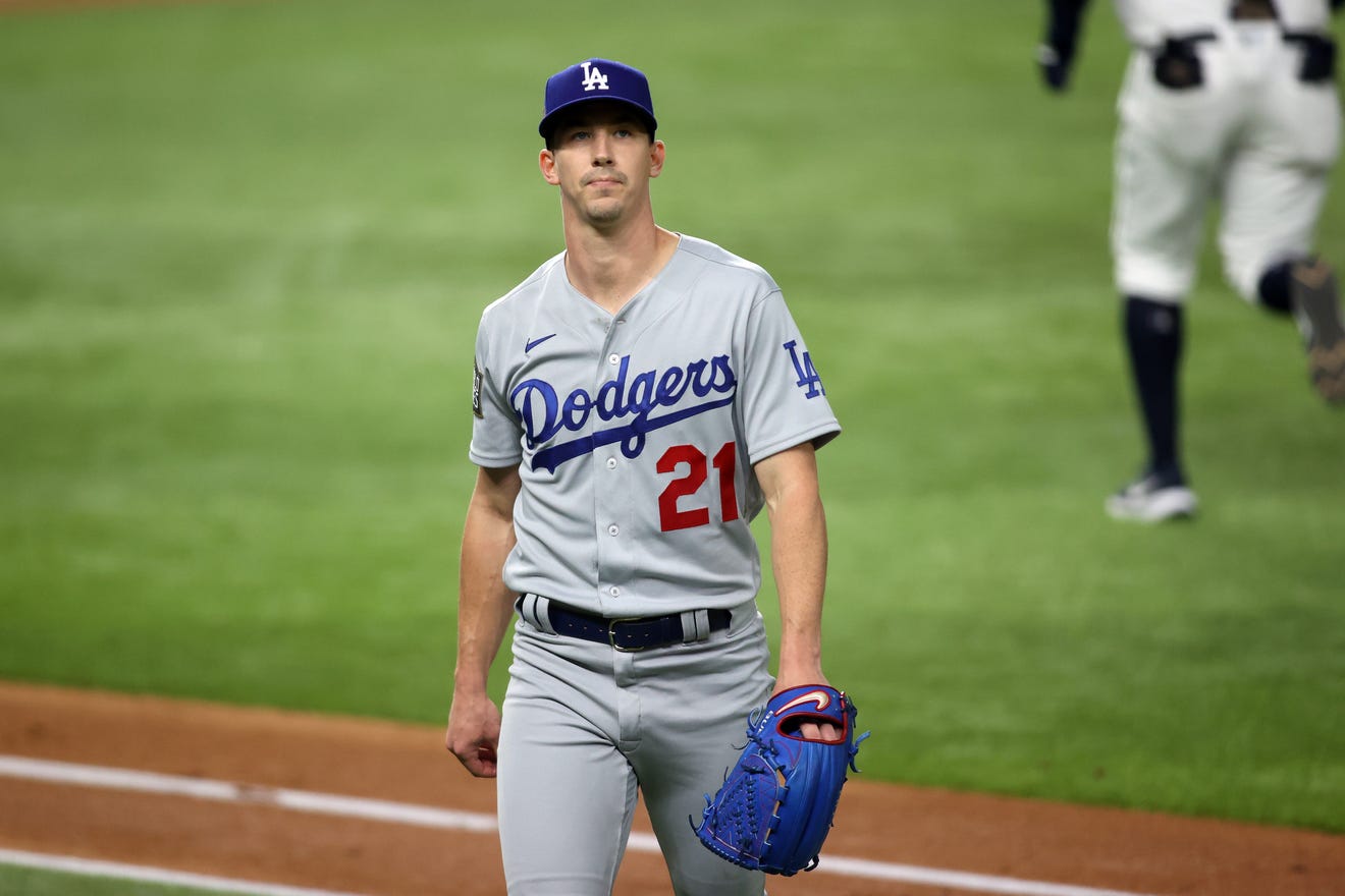 Game 3: Dodgers starting pitcher Walker Buehler walks off the field to end the first inning.