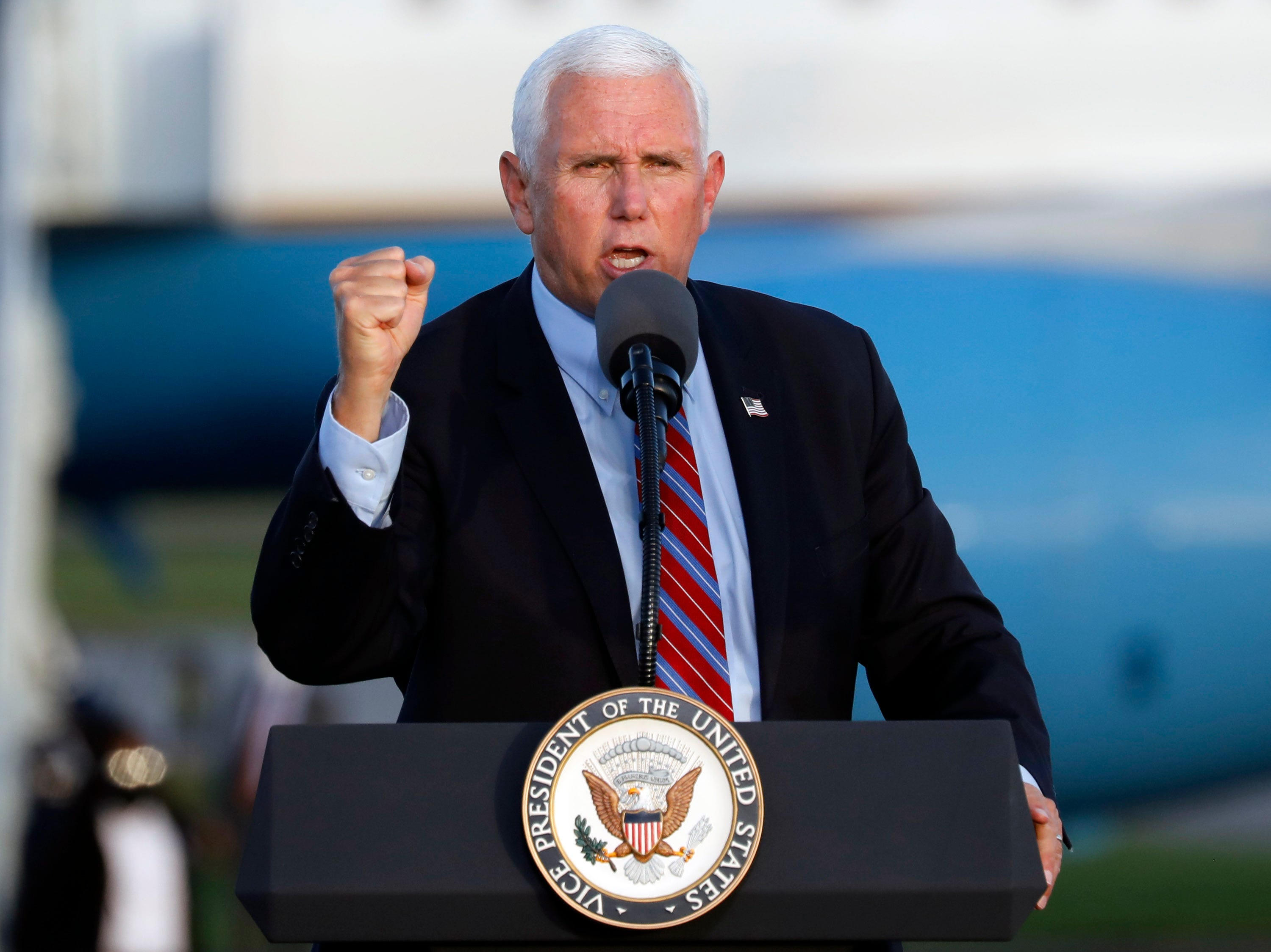 Vice President Mike Pence stirs up a crowd of more than 1,000 people during the "Make America Great Again Victory Rally" at Lakeland Linder International Airport on Saturday.