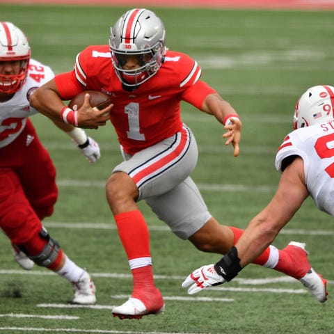 Ohio State quarterback Justin Fields runs for yard