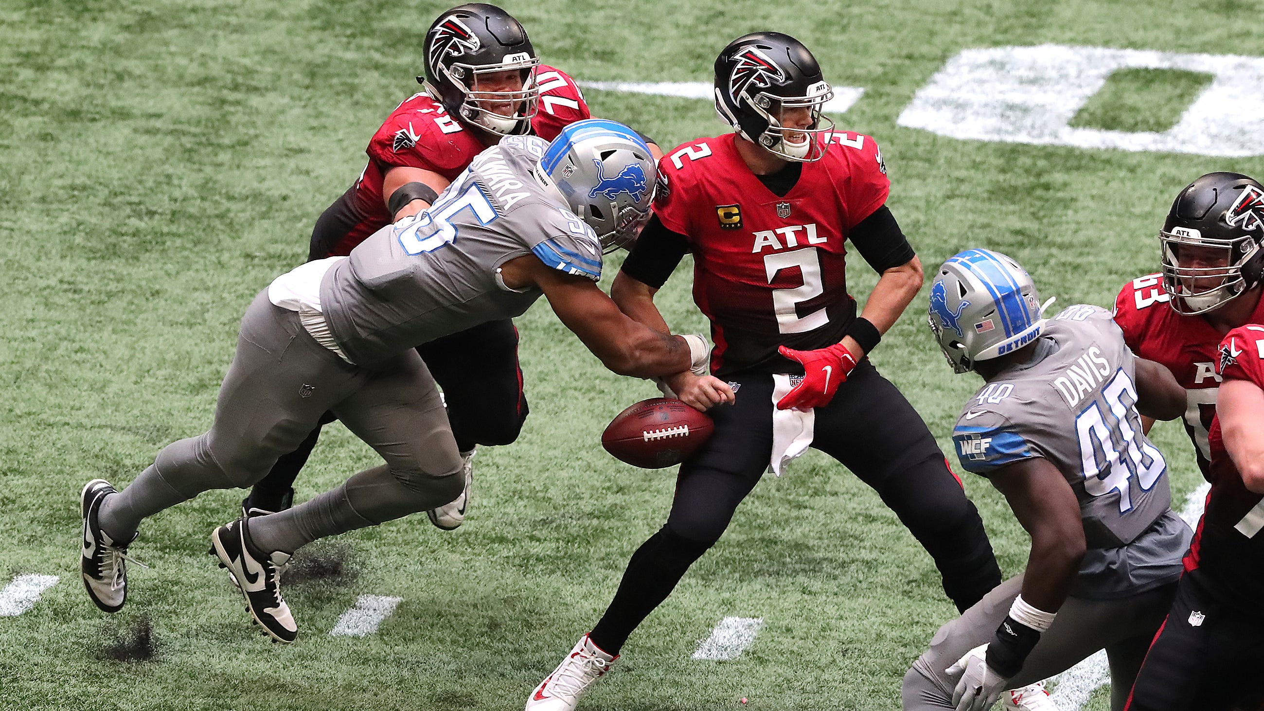 Lions defensive end Romeo Okwara strips the ball from Falcons quarterback Matt Ryan during the fourth quarter.