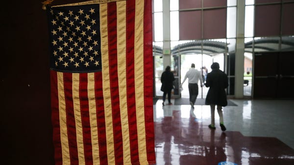 People walk out of a Vote Center located at Compto