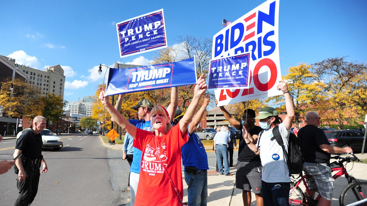 President Donald Trump supporters and Democratic presidential candidate Joe Biden supporters square off in front of Penn Place office building in Wilkes-Barre, Pa., Thursday, Oct. 22, 2020. The Luzerne County Election Bureau is located inside Penn Place where early walk-in voting has started.