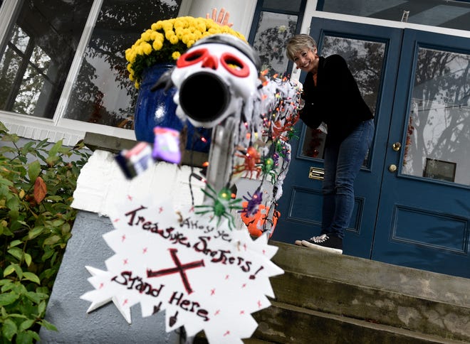 Carol McCarthy sends candy down the candy chute Monday that she will use to give out treats to socially-distant trick-or-treaters on Halloween in Palmyra, N.J.