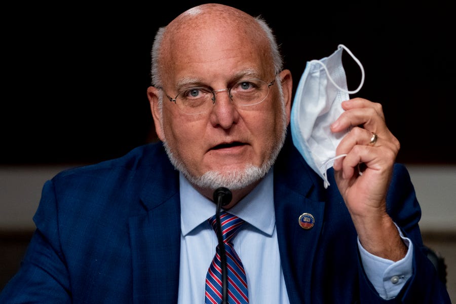 Centers for Disease Control and Prevention Director Dr. Robert Redfield holds up his mask as he speaks at a Senate Appropriations subcommittee hearing on a "Review of Coronavirus Response Efforts" on Capitol Hill, Wednesday, Sept. 16, 2020, in Washington.