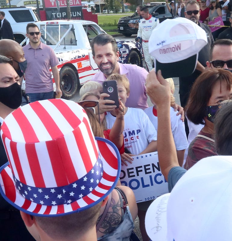 Donald Trump Jr. takes a photograph with some young fans Wednesday, October 28, 2020 during a campaign stop for his father, President Donald Trump, at Volusia Top Gun in Daytona Beach.