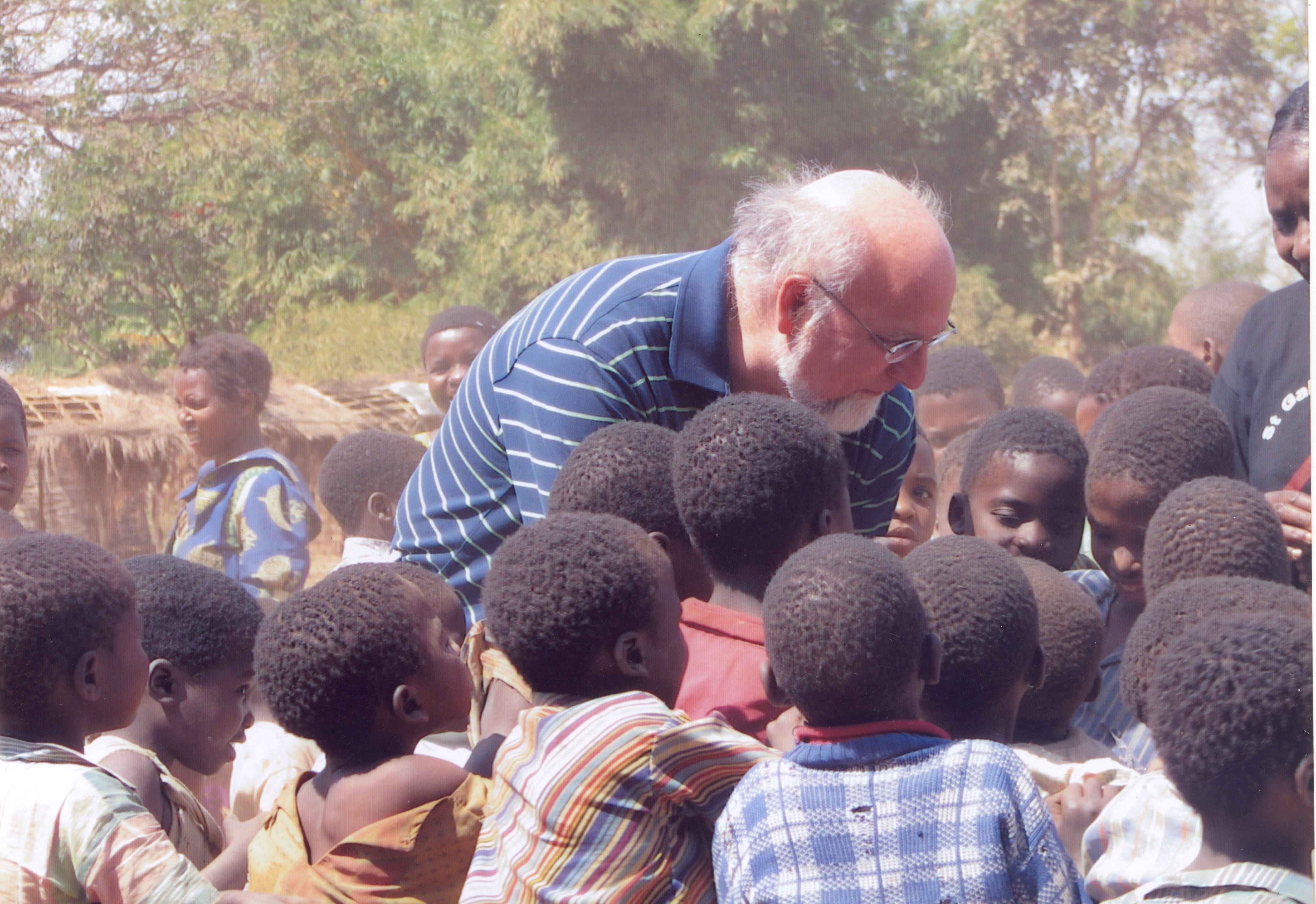 Dr. Robert Redfield, CDC director, while at the Institute of Human Virology at the University of Maryland School of Medicine. Here greeting a group of children in Africa.