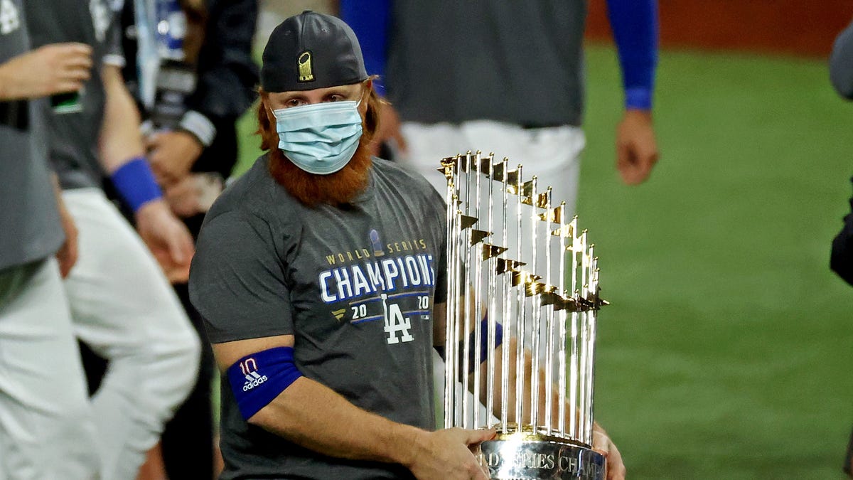 Los Angeles Dodgers third baseman Justin Turner celebrates with the Commissioner's Trophy after winning the World Series.