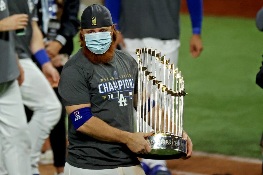 Los Angeles Dodgers third baseman Justin Turner celebrates with the Commissioner's Trophy after winning the World Series.