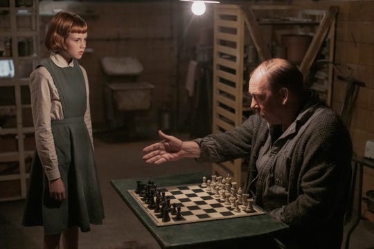 Isla Johnston as Young Beth and Bill Camp as Mr. Shaibel in "The Queen's Gambit."