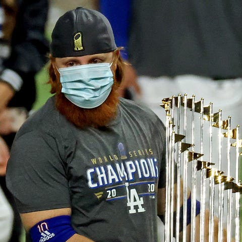 Justin Turner holds the World Series trophy on the