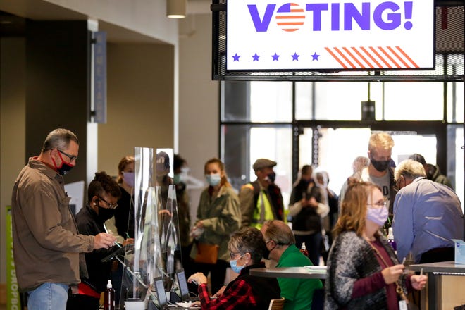 Voters check in before casting their ballots ahead of the 2020 general election at Northview Church, Wednesday, Oct. 28, 2020 in West Lafayette.