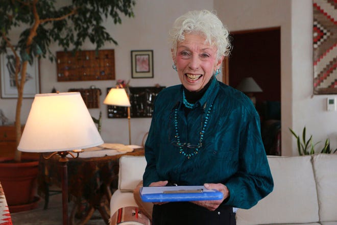 Get-out-the-vote letter writer Nancy Gehman poses for a photo at her home on Tuesday, Oct. 27, 2020, in Santa Fe, New Mexico. Gehman is one of 182,000 people who have participated in Vote Forward, a 50-state letter-writing campaign to more than 17.5 million homes. In the best of times, itâ€™s a massive logistical challenge to get millions out to vote. In 2020, the difficulty has been dramatically compounded: by fear of the coronavirus, by complications and confusion over mail-in ballots, by palpable anxiety over the bitter divisions in the country. (AP Photo/Cedar Attanasio)