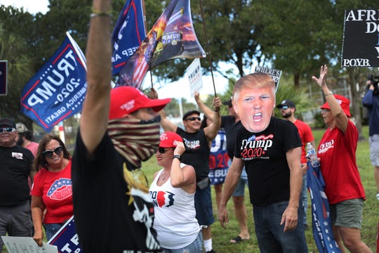 Supporters of President Donald Trump demonstrate together at the place where the Democratic presidential nominee Biden held a campaign rally on October 29, 2020 at Broward College North Campus in Coconut Creek, Florida.