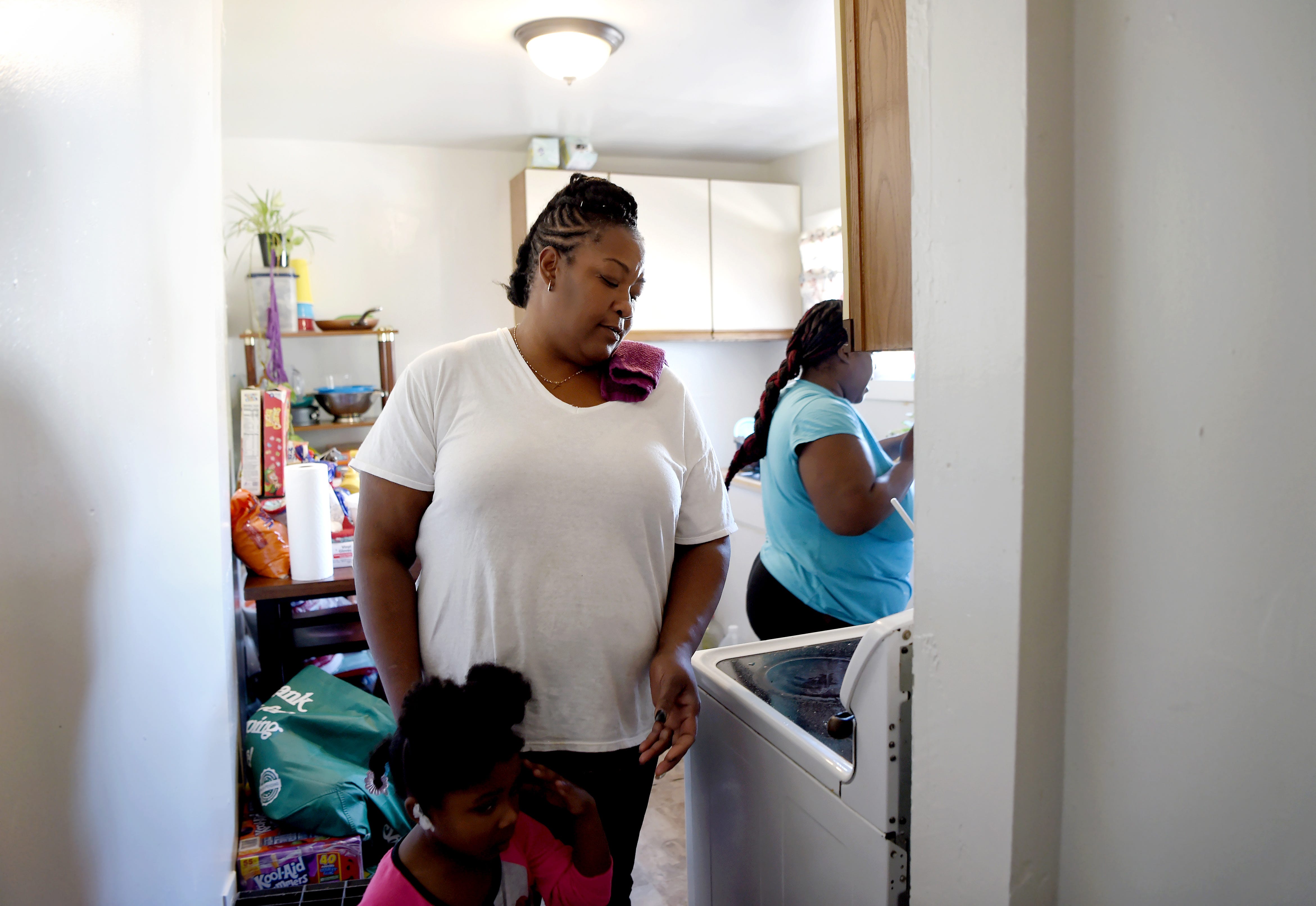 Davita Bateman leads her granddaughter Phoenix Barnett from the kitchen of the family's Binghamton apartment as her daughter, Brittany Barnett prepares a meal. The family of five currently share a two-bedroom apartment but Bateman is taking homeownership classes and budgeting so she can soon purchase a house for her family. October 15, 2020. 