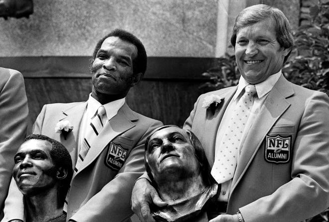 Herb Adderly and Jim Otto pose with their busts after enshrinement in the Pro Football Hall of Fame in Canton, Ohio, Aug. 2, 1980.