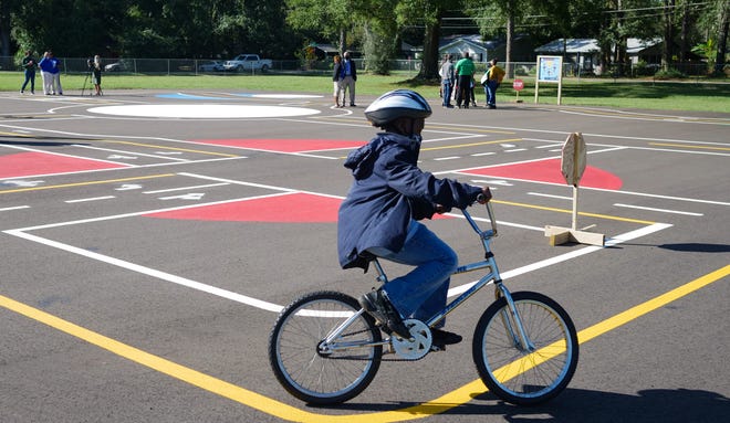 A student rides a bicycle on Sabal Palm Elementary's new educational bicycle park on Friday, Oct. 30, 2020.