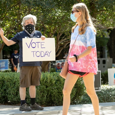 Kim Ludeke, left, encourages students to vote at a