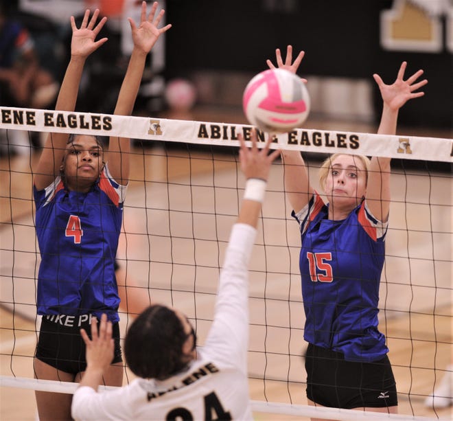 San Angelo Central's Peyton Mayberry (4) and Amory Fly (15) defend at the net as Abilene High's Mia Cairo hits the ball. Central beat AHS 25-13, 25-17, 25-15 in the District 2-6A match Saturday, Oct. 31, 2020, at Eagle Gym.
