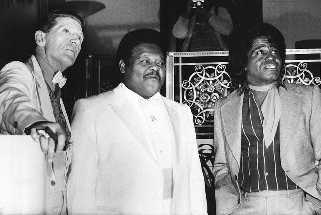 This Jan. 23, 1986 file photo, from left, musicians Jerry Lee Lewis, Fats Domino and James Brown pose at a reception where they were inducted into the Rock and Roll Hall of Fame at the Waldorf-Astoria Hotel in New York. Domino and Lewis are Louisiana natives.