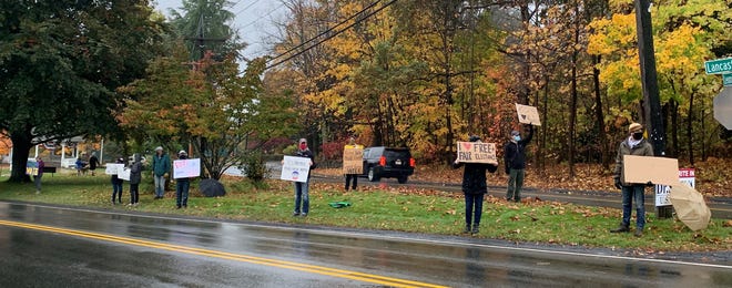 Members of the North Central Mass. Election Defense Team hold signs on the Lunenburg common last week to promote a fair election. A similar stand-out was held Oct. 27 at the Twin City Plaza in Leominster.