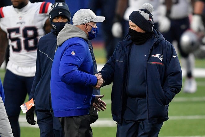 Buffalo Bills' head coach Sean McDermott (left) and New England Patriots' head coach Bill Belichick shake hands after Sunday's game, presumably not to talk about how to legally talk on a cell phone at halftime of an NFL game.