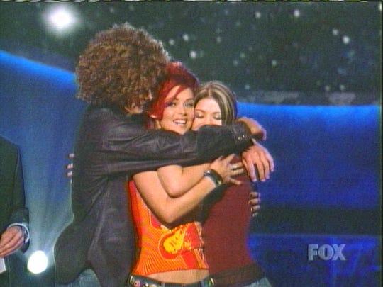 Justin Guarini, Nikki McKibbin and Kelly Clarkson hug after McKibbin was voted off the show in 2002.