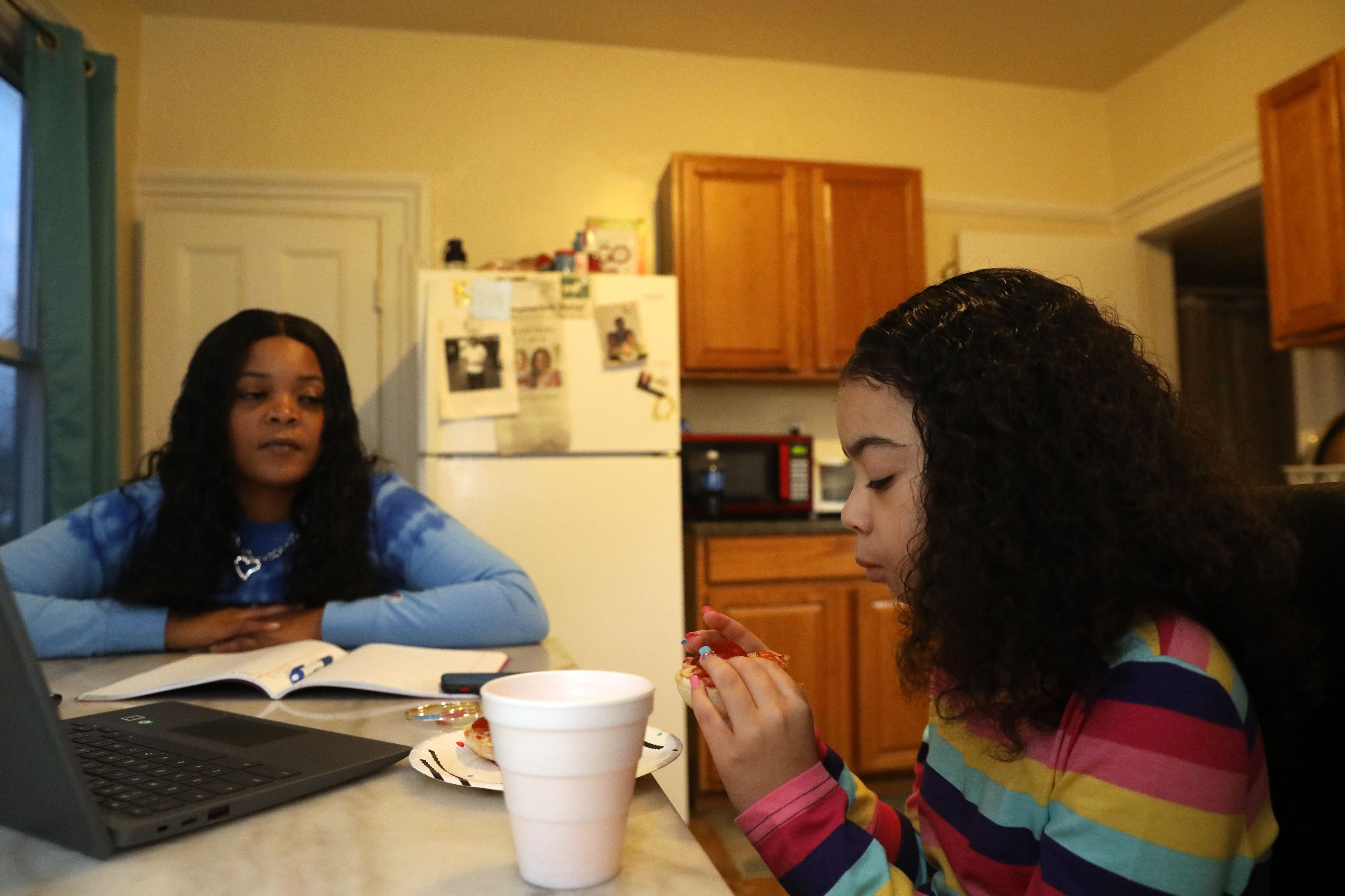 Taking a break from homework, Kendra Smith and Diamond Yeno eat their homemade English Muffin pizzas at their home in the City of Poughkeepsie on October 29, 2020. 