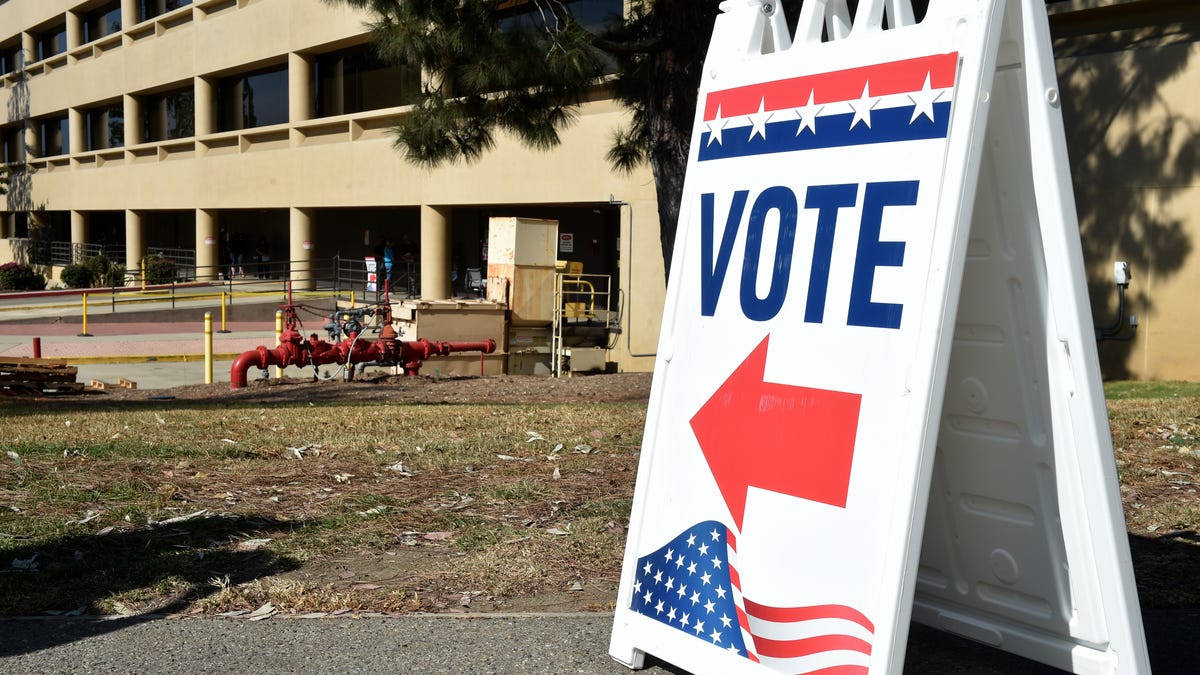 Nearly two dozen voters line up at the Ventura County Elections Division office to vote in Ventura on Nov. 2, 2020.