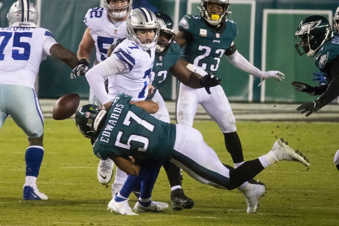 The Eagles' T.J. Edwards forces a fumble as he brings down Dallas quarterback Ben DiNucci on Sunday.