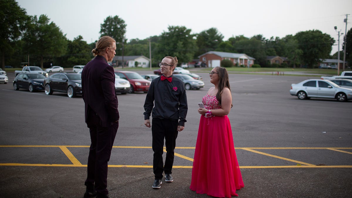 Principal Ryan Jackson welcomes Jhase Scott and Morgan Dickey to the prom at Mt. Pleasant High School in Maury County, Tenn., on Saturday, June 27, 2020.