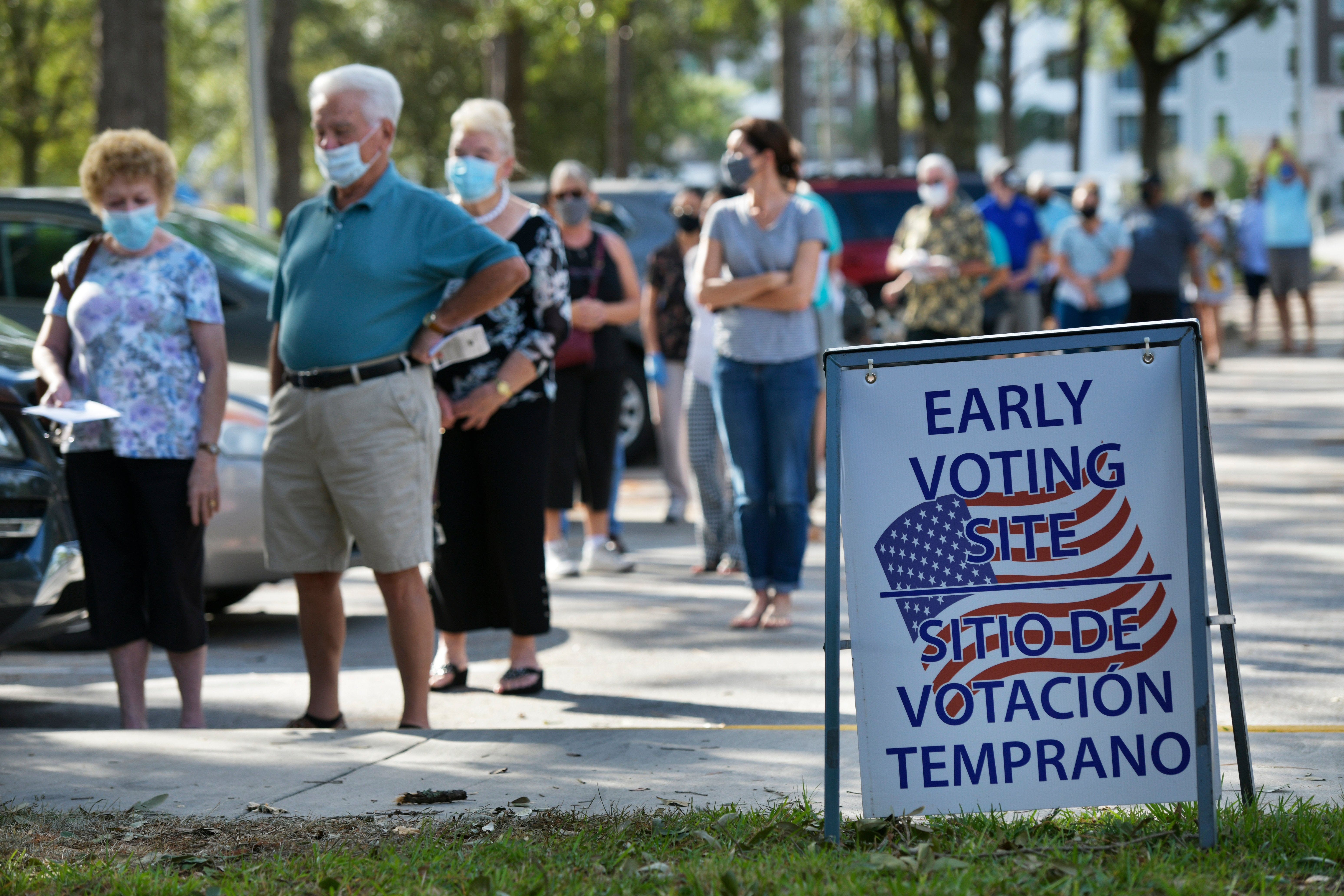 Voters wait in a long line in mid-morning at the Southeast Regional Library Monday, October 19, 2020 on the first day of early voting in Jacksonville, Florida. (Will Dickey/Florida Times-Union)