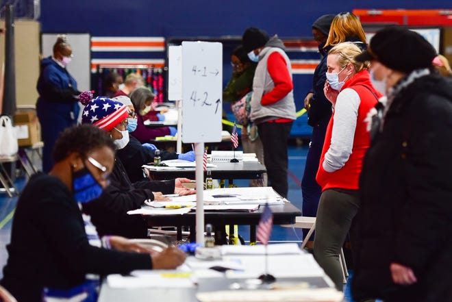 People prepare to vote on Election Day at the Parkway Center on Tuesday, Nov. 3, 2020 in Utica.