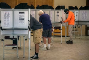 Voters fill out their ballots at the polling place at Burgundy Hall on the Lodi Grape Festival grounds Lodi.