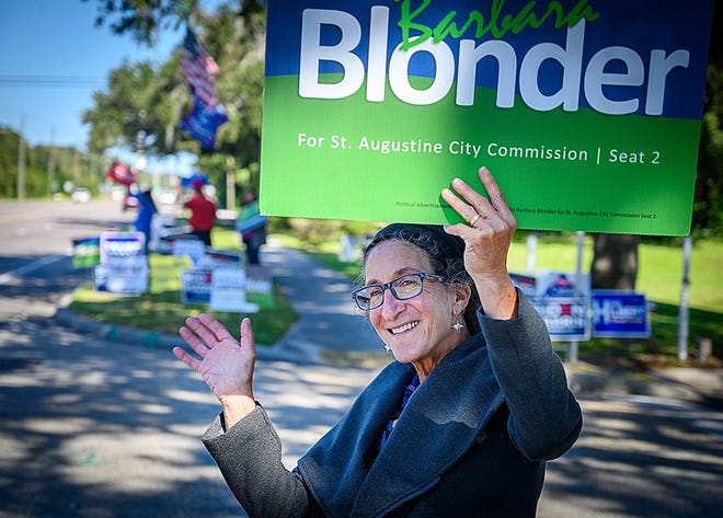 Barbara Blonder waves to motorists as they drive down Anastasia Boulevard on general election day on Tuesday, Nov. 3, 2020. Blonder, who defeated Leanna Freeman in the election, will take her oath of office on Monday.