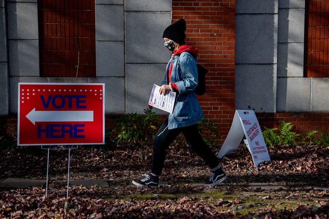 A voter walks toward the gym entrance to cast a ballot at Montford North Star Academy on Election Day, Nov. 3, 2020. 
