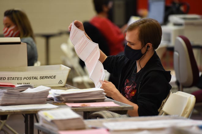 Board of Election workers process ballots at the Passaic County Community College gym in Paterson on November 03, 2020. 