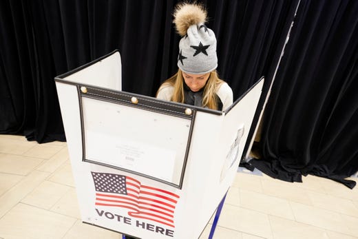 Stacy Glass marks her ballot during the first hour of voting in New York at Madison Square Garden, Tuesday, Nov. 3, 2020.