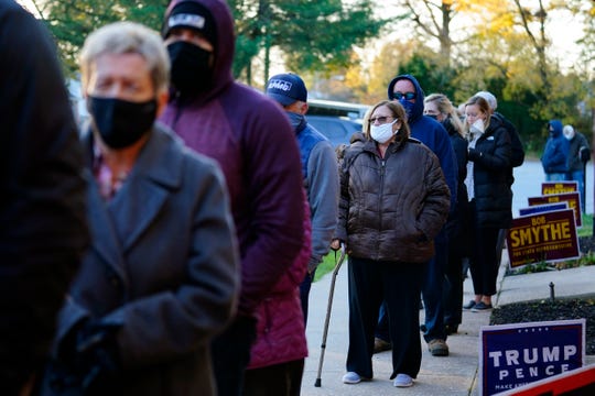 People line up outside a polling place to vote in the 2020 general election in the United States, Tuesday, Nov. 3, 2020, in Springfield, Pennsylvania.