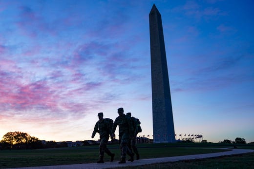 United States National Guard members walk towards the White House from the Washington Monument on Election Day, Tuesday, Nov. 3, 2020, in Washington.