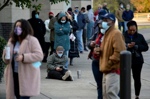 People wait in line to vote at the polling location at Antioch High School on Tuesday, November 3, 2020 in Antioch, Tenn.