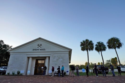 People wait in line to cast their vote at sunrise on Election Day Tuesday, Nov. 3, 2020, in Riverview, Fla.